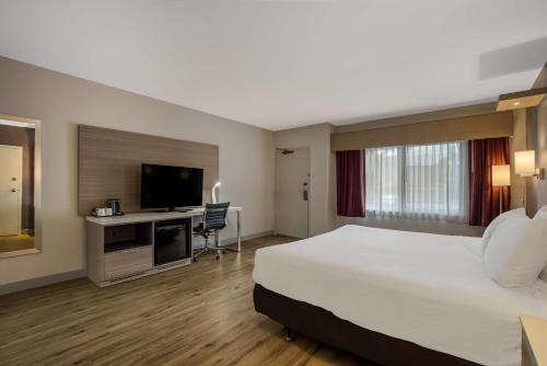 a hotel room with a large bed and a desk at Best Western Diamond Bar Hotel & Suites in Diamond Bar
