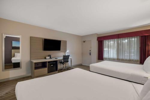 a hotel room with two beds and a television at Best Western Diamond Bar Hotel & Suites in Diamond Bar