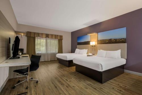 a hotel room with two beds and a desk at Best Western Diamond Bar Hotel & Suites in Diamond Bar