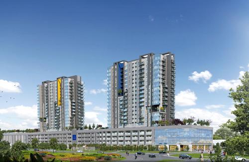 two tall buildings in a city with a parking lot at Diamond Apartment 158- Luxury in Skopje in Skopje