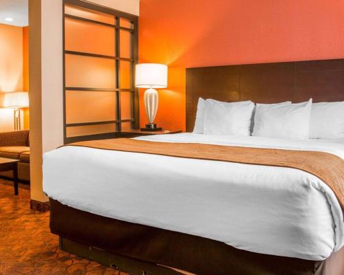 a hotel room with a large bed in a room at Comfort Inn & Suites and Conference Center in Mount Pleasant