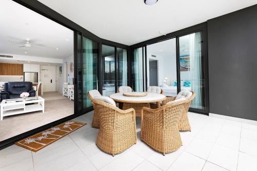 a living room with a table and chairs at Solaris 310 in Forster