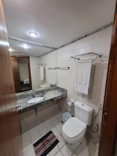 a bathroom with a toilet and a sink at 705 Flat hotel Taguatinga in Brasília