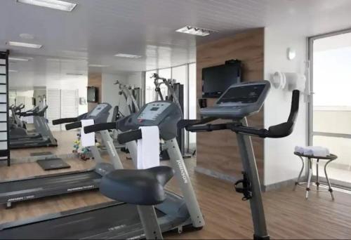 a gym with several tread machines and a treadmill at 512. Flat hotel Go Inn in Brasilia