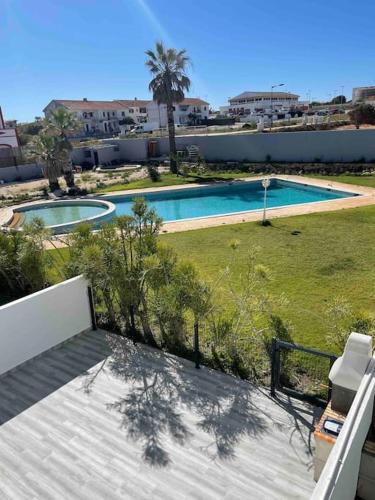a view of a swimming pool from the balcony of a house at Cantinho de Sagres in Sagres