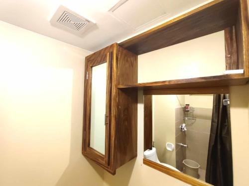 a bathroom with a mirror and a toilet at Avida Iloilo Tower 3 411 in Iloilo City