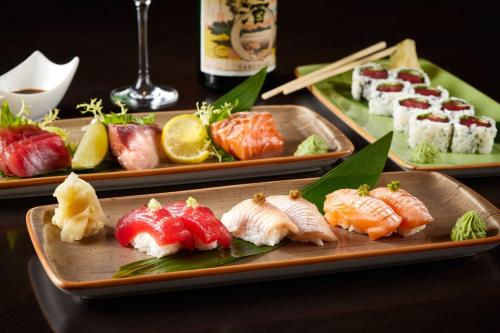 two trays of sushi on a table with at The Ritz-Carlton, Tysons Corner in Tysons Corner