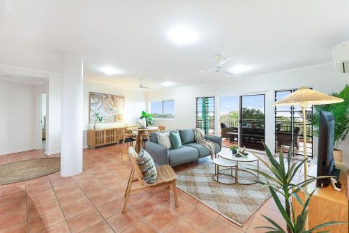 a living room with a couch and a tv at Harbour Haven - A Parkside CBD Address in Darwin