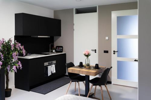 a kitchen with a table and chairs and a stove at Luxury room with king size bed in Dordrecht