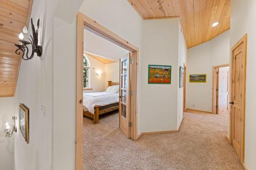 a bedroom with a bed and a door leading into a room at Fox Crossing at Tahoe Donner Vacation Rental w Forested Views in a Prime Location in Truckee