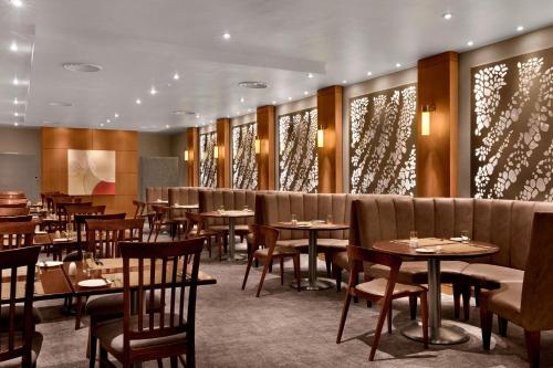 a restaurant with tables and chairs in a room at The Westin Cape Town in Cape Town