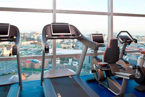 a gym with cardio machines in a large window at The Westin Cape Town in Cape Town
