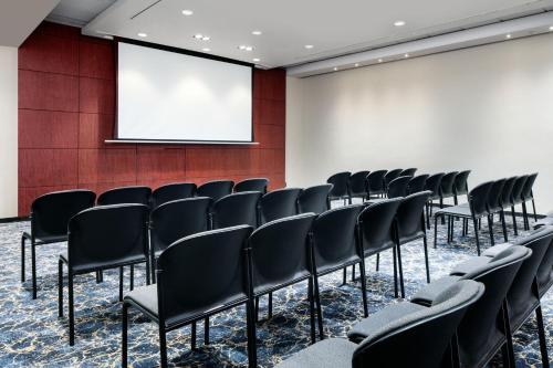 a conference room with black chairs and a screen at The Westin Cape Town in Cape Town
