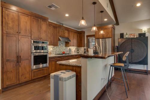 a kitchen with wooden cabinets and a counter top at Truckee Luxe by Tahoe Getaways - 3 BR Luxury Gray's Crossing Townhome w Hot Tub on Golf Course - Close to Downtown & Northstar in Truckee