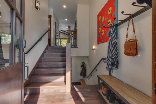 a staircase in a house with wooden floors at Truckee Luxe by Tahoe Getaways - 3 BR Luxury Gray's Crossing Townhome w Hot Tub on Golf Course - Close to Downtown & Northstar in Truckee