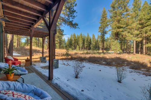 a covered porch with a view of a river at Truckee Luxe by Tahoe Getaways - 3 BR Luxury Gray's Crossing Townhome w Hot Tub on Golf Course - Close to Downtown & Northstar in Truckee