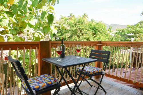 a table with two glasses of wine on a deck at Bungalows Teka in Zihuatanejo