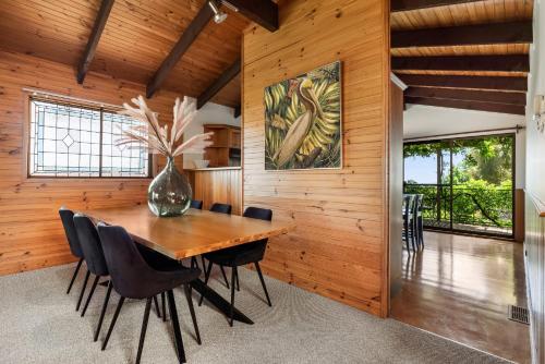 a wooden dining room with a wooden table and chairs at Sunset Lodge - Breathtaking Views in Orange