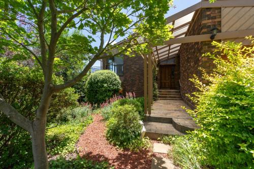 a house with a walkway leading to the front door at Sunset Lodge - Breathtaking Views in Orange