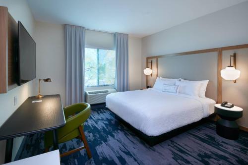 a hotel room with a bed and a window at Fairfield Inn & Suites by Marriott Midland in Midland