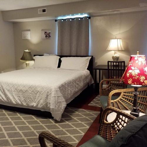 a bedroom with a bed and a lamp and a chair at Fairmount House Free Street Parking Quiet Spacious in Philadelphia