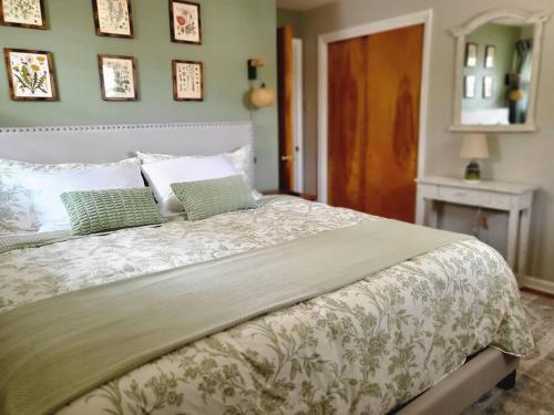 a bedroom with a large bed with green walls at Private space, while visiting family this Holiday! in Pottstown