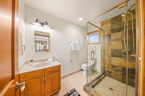 a bathroom with a shower and a sink and a toilet at Sunlit Pines by Tahoe Getaways - 2BR in Tahoe Park w Hot Tub, Fenced Yard & Pet Friendly! in Tahoe City