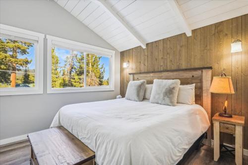 a bedroom with a white bed and two windows at Granlibakken Getaway- West Shore Retreat-Central Location-Hot Tub-Near Skiing in Tahoe City