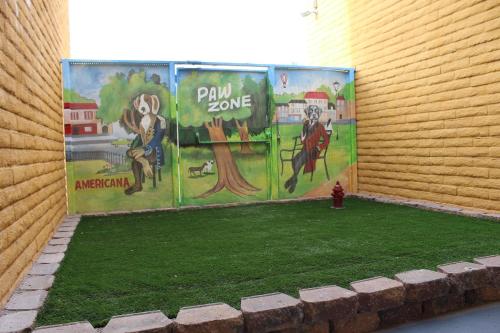 a wall with paintings on the side of a building at Hotel Americana in Nogales