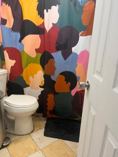 a bathroom with a colorful mural on the wall at Beds & Sheets Little Havana in Miami