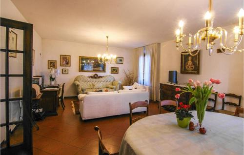 a living room with a bed and a table with flowers at 5 Bedroom Nice Home In Castelvecchio Di Comp, in Castelvecchio