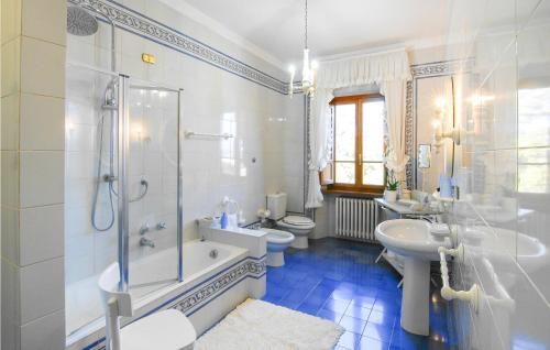 a bathroom with a tub shower and a sink and a toilet at 5 Bedroom Nice Home In Castelvecchio Di Comp, in Castelvecchio