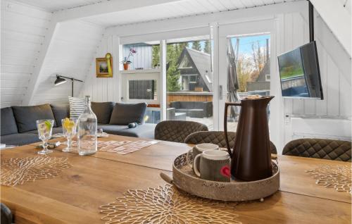 a dining room with a table with a vase on it at Amazing Home In Farsø With Wifi in Farsø