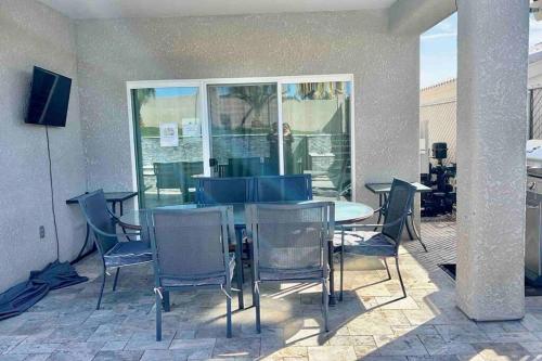 a table and chairs sitting on a patio at Paradise Oasis! Waterfall pool & spa in Lake Havasu City