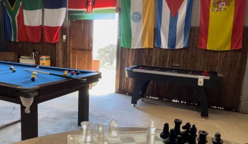 two pool tables in a room next to a table with a pool table at Rose Quartz - 1 Bed with Mountain Views - Kundalini Lodge in Grattai