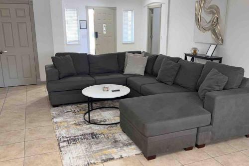 a living room with a couch and a coffee table at Spacious Getaway! Pool, Spa, Sleeps 9 in Lake Havasu City