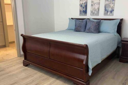 a large bed with blue pillows on top of it at Spacious Getaway! Pool, Spa, Sleeps 9 in Lake Havasu City