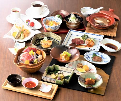 a table with plates of food and bowls of food at Hotel Mori no Kaze Nasu in Nasu