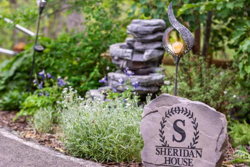 a garden with a rock and a garden house at Sheridan House Inn- Adult Only Accommodation in Williams