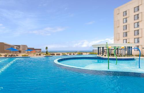 a large swimming pool in front of a building at Seda Manila Bay in Manila