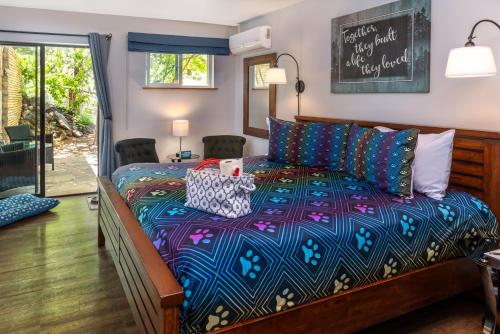 a bedroom with a bed with a colorful comforter at Sheridan House Inn- Adult Only Accommodation in Williams