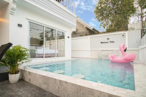 a swimming pool with an inflatable flamingo in the middle of a house at Mohana Pool villa 4 bedrooms near walking street in Pattaya South