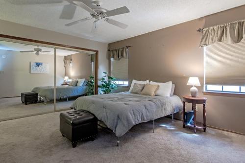 a bedroom with a bed and a large mirror at Bright & spacious home with pool in Albuquerque