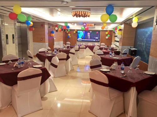 a banquet hall with tables and chairs and balloons at HOTEL STUDiO23 in Dhaka