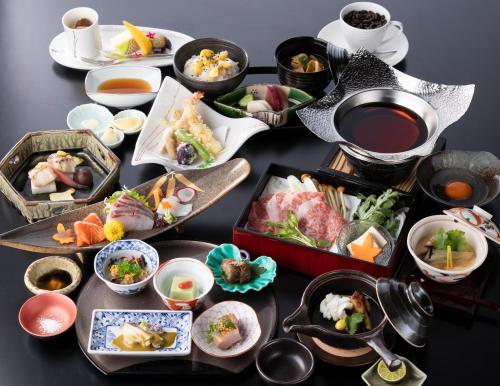a table topped with different types of food and tea at Hotel Morinokaze Hakone Sengokuhara in Hakone