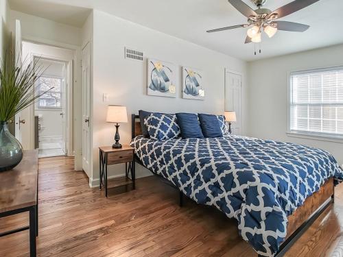 a bedroom with a bed and a ceiling fan at 4 Bedroom Plaza Charmer Pet Friendly in Kansas City