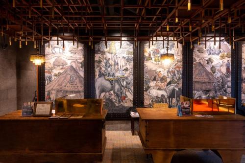 a room with a wall with a painting on the wall at Payaa Hotel in Pattaya