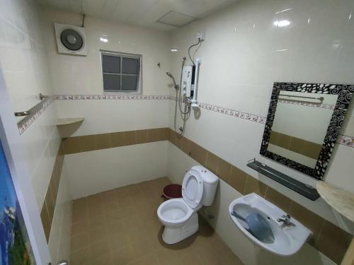 a bathroom with a toilet and a sink at Crown imperial in Brinchang