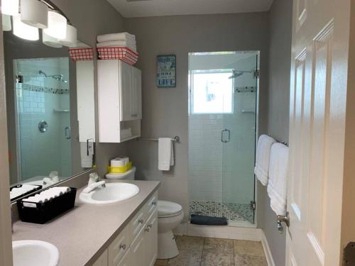 a bathroom with a shower and a sink and a toilet at Coastal Sea Side Townhome in Clearwater Beach