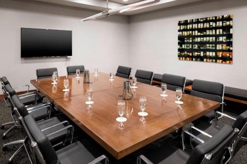 a conference room with a large wooden table and chairs at Le Méridien Chicago - Oakbrook Center in Oak Brook